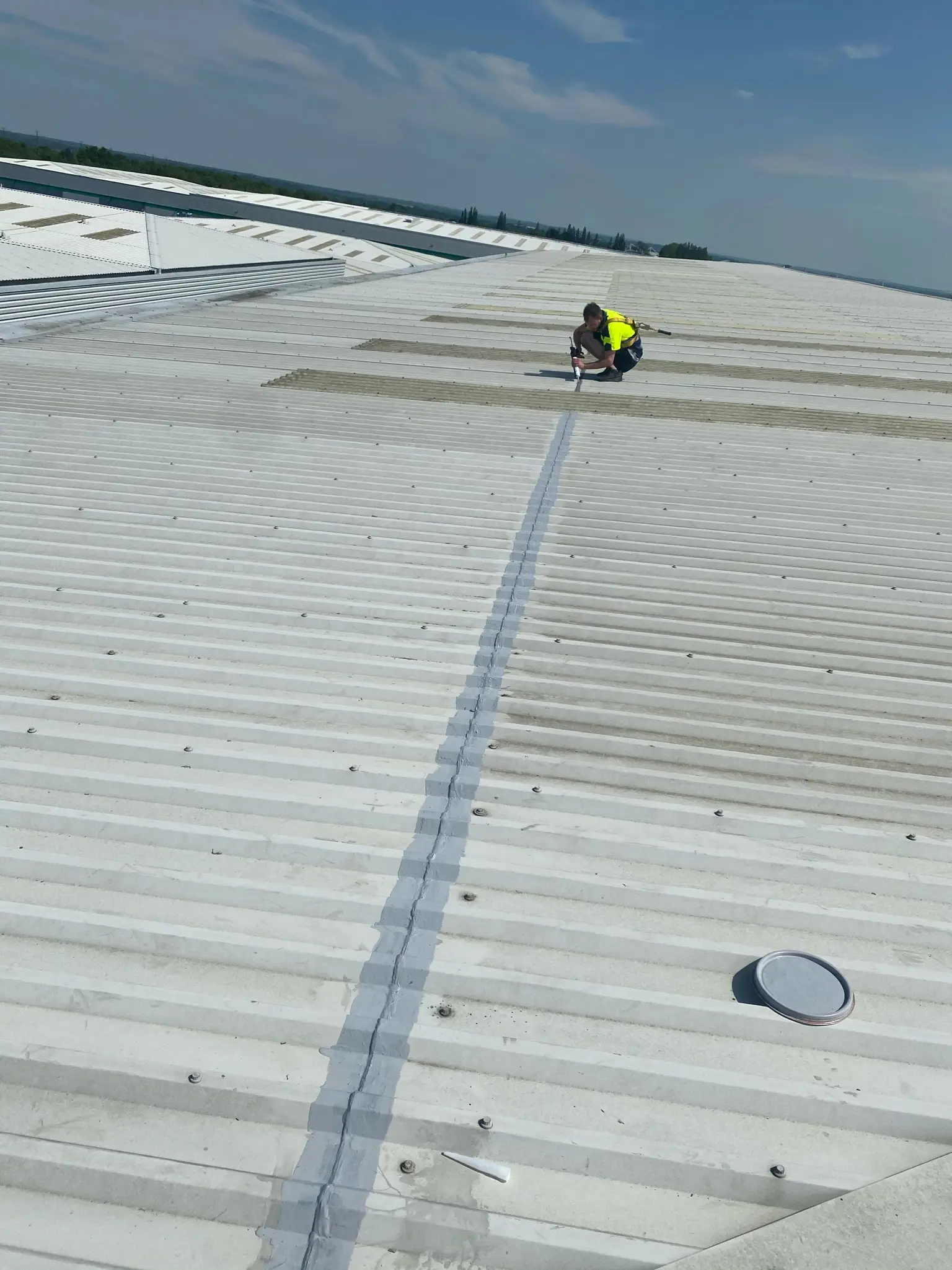 Cut edge restoration and roof coating on a commercial building by DMC Facilities Management